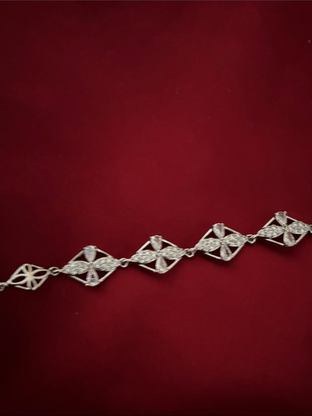 Silver  bracelet features a delicate filigree chain adorned with sparkling cubic